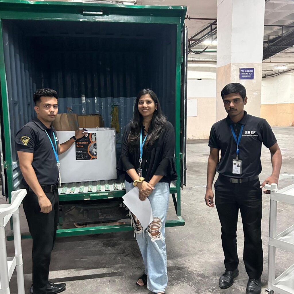 Amazon employees getting clicked with the clothes donation boxes during Global Volunteering Month.