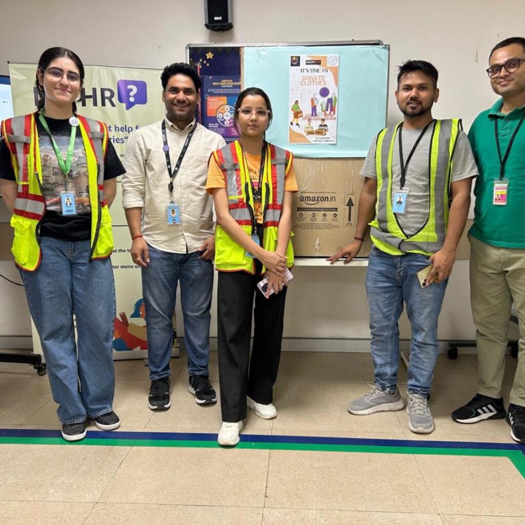 Joyful Amazon employees at a donation drive for Global Volunteering Month, partnered with Share At Door Step.