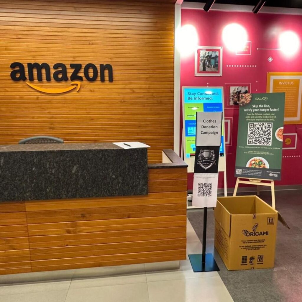 Amazon office with donation boxes during Global Volunteering Month, powered by Share At Door Step, for a nationwide donation drive.