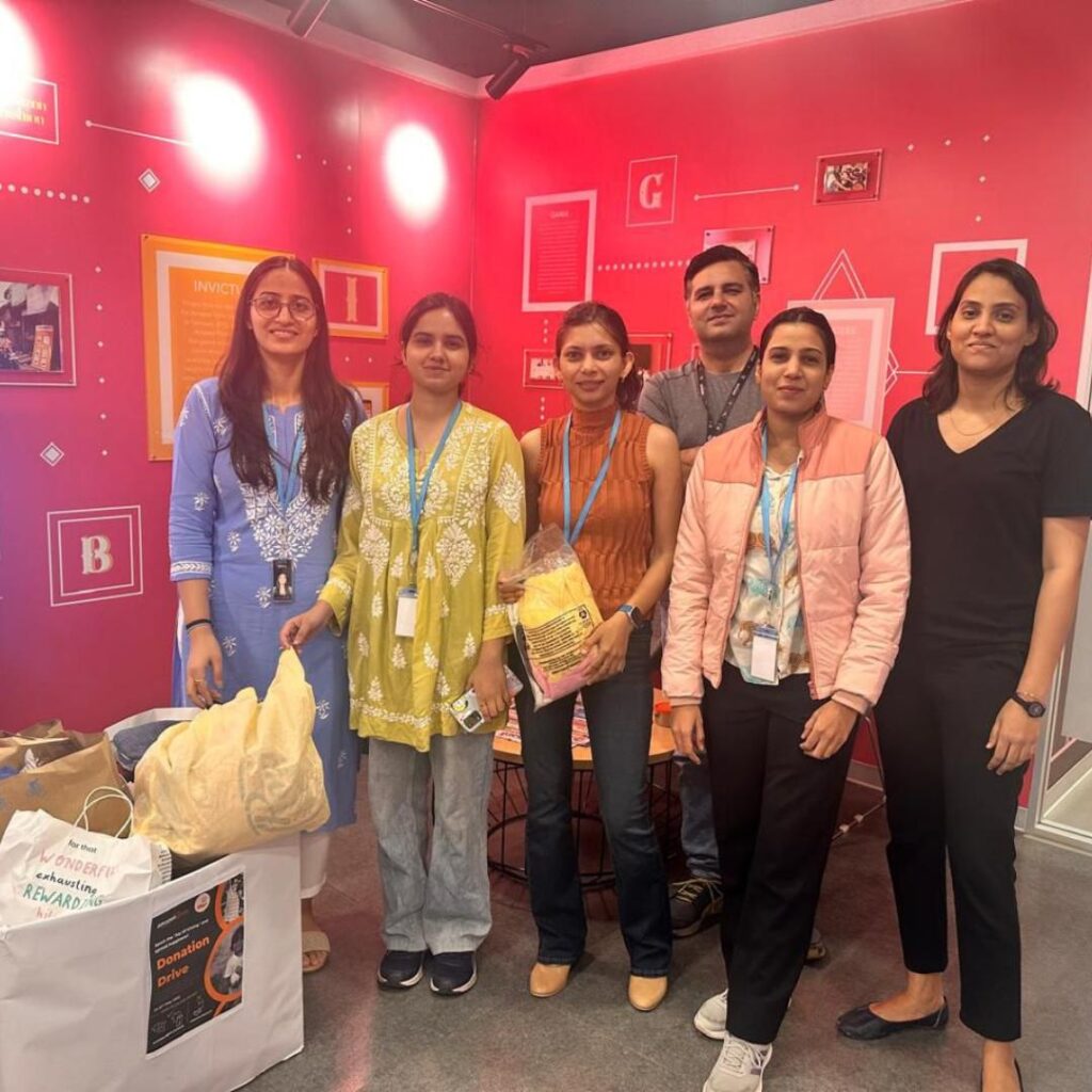 Happy Amazon employees during Global Volunteering Month donation drive with Share At Door Step, showcasing engagement and joy.