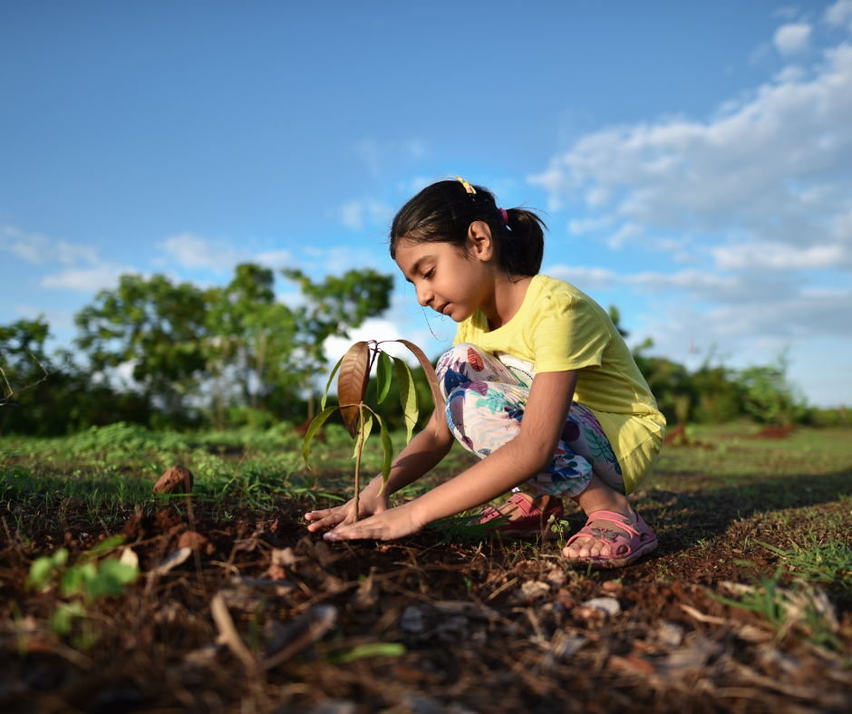 A girl planting a tree on Earth Day 